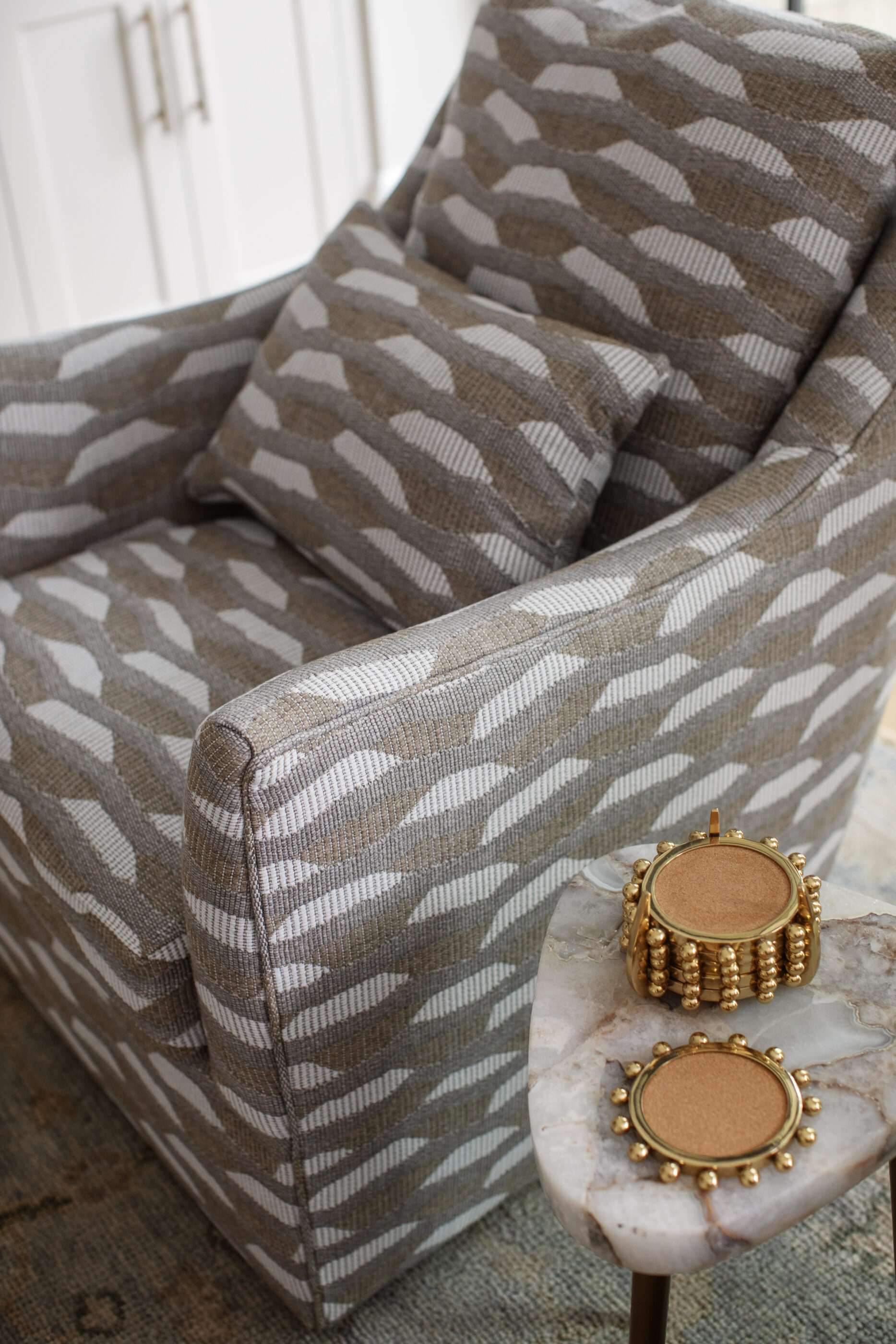 “Lowcountry luxury interior design by Megan Molten featuring coastal modern style, custom upholstery, woven textures, and statement lighting in a serene Kiawah home. Soft blues, neutrals, and sandy tones create an airy atmosphere across kitchen, living room, bedroom, bathroom, and poolside spaces