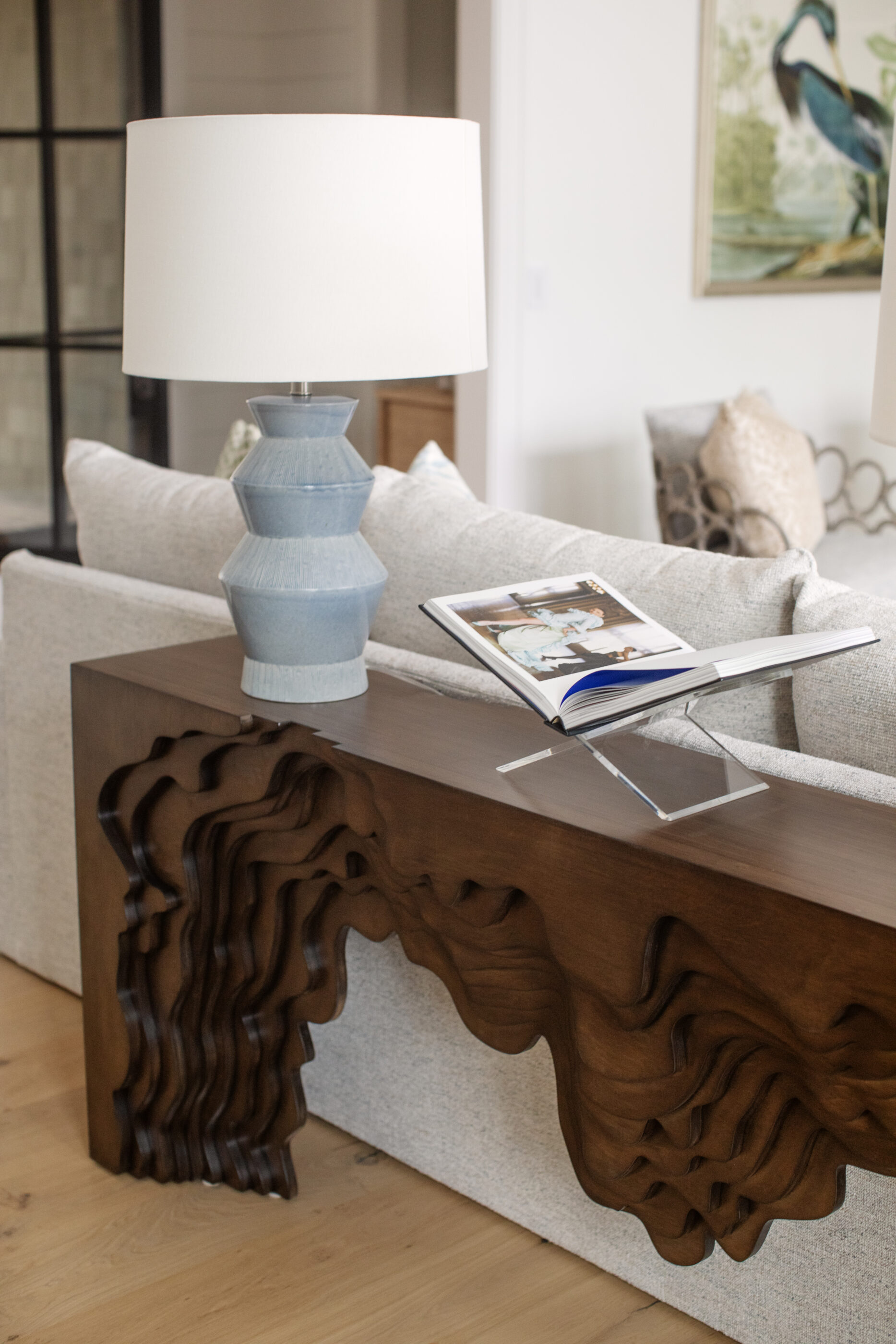 “Lowcountry luxury interior design by Megan Molten featuring coastal modern style, custom upholstery, woven textures, and statement lighting in a serene Kiawah home. Soft blues, neutrals, and sandy tones create an airy atmosphere across kitchen, living room, bedroom, bathroom, and poolside spaces