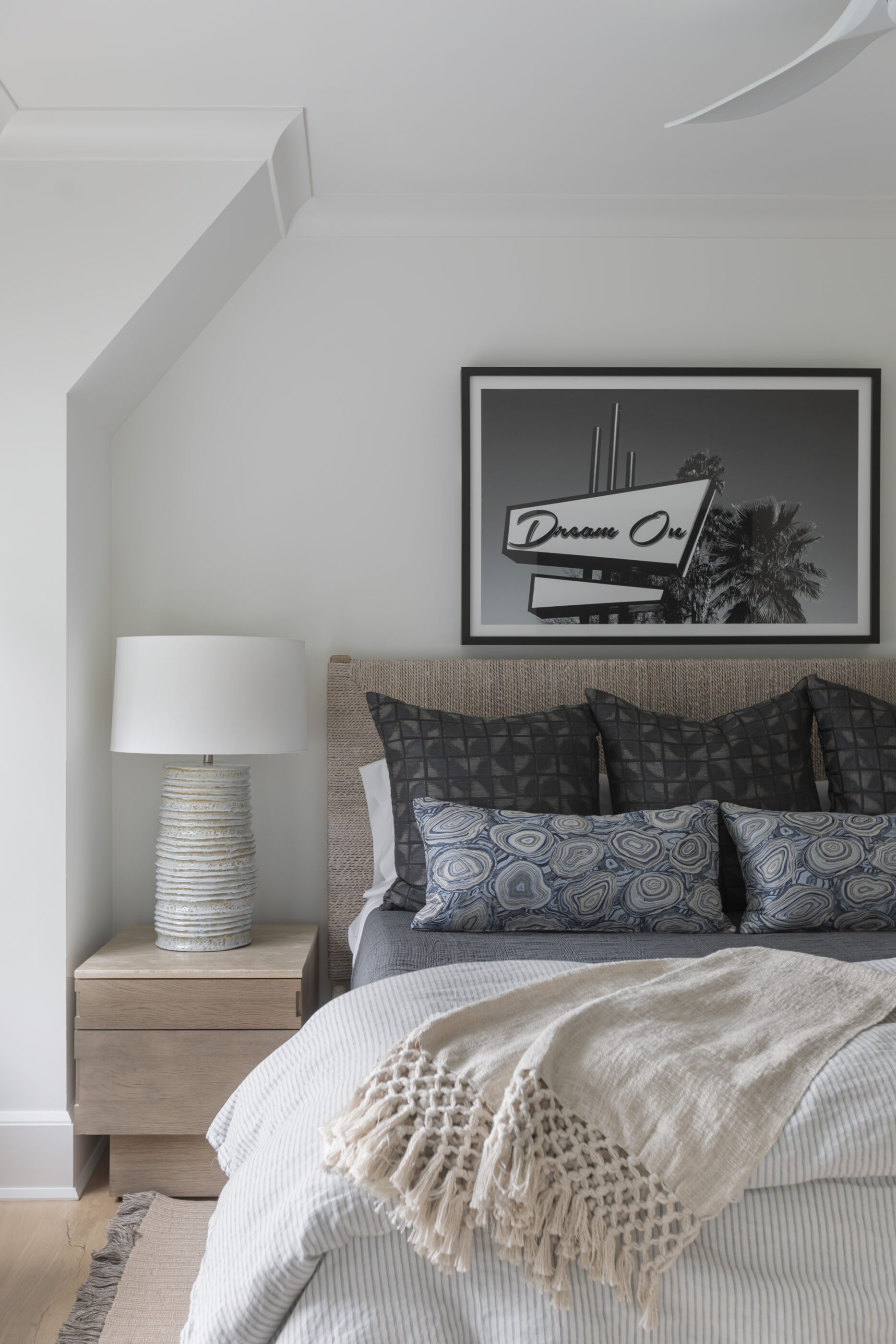 “Lowcountry luxury interior design by Megan Molten featuring coastal modern style, custom upholstery, woven textures, and statement lighting in a serene Kiawah home. Soft blues, neutrals, and sandy tones create an airy atmosphere across kitchen, living room, bedroom, bathroom, and poolside spaces