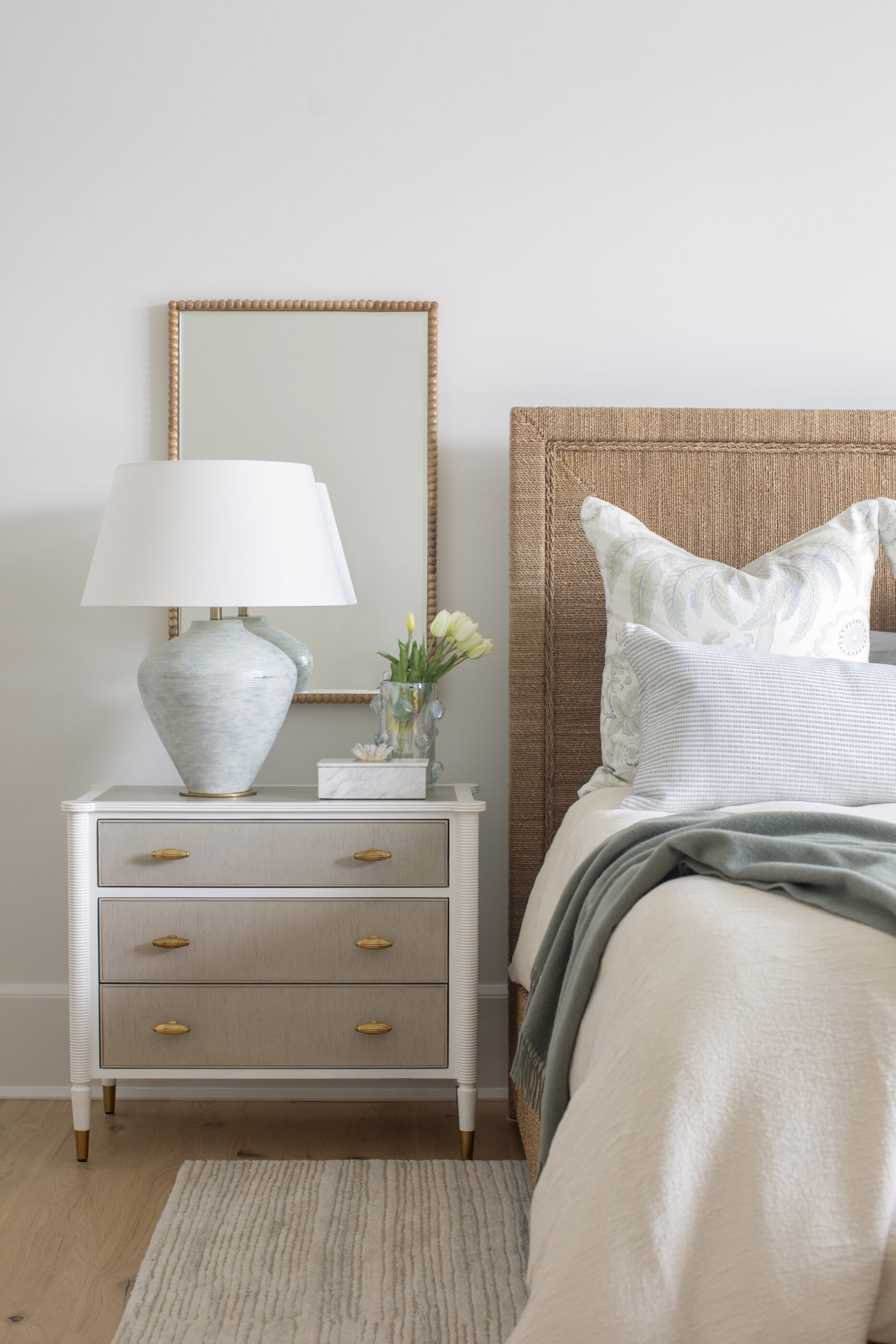 “Lowcountry luxury interior design by Megan Molten featuring coastal modern style, custom upholstery, woven textures, and statement lighting in a serene Kiawah home. Soft blues, neutrals, and sandy tones create an airy atmosphere across kitchen, living room, bedroom, bathroom, and poolside spaces