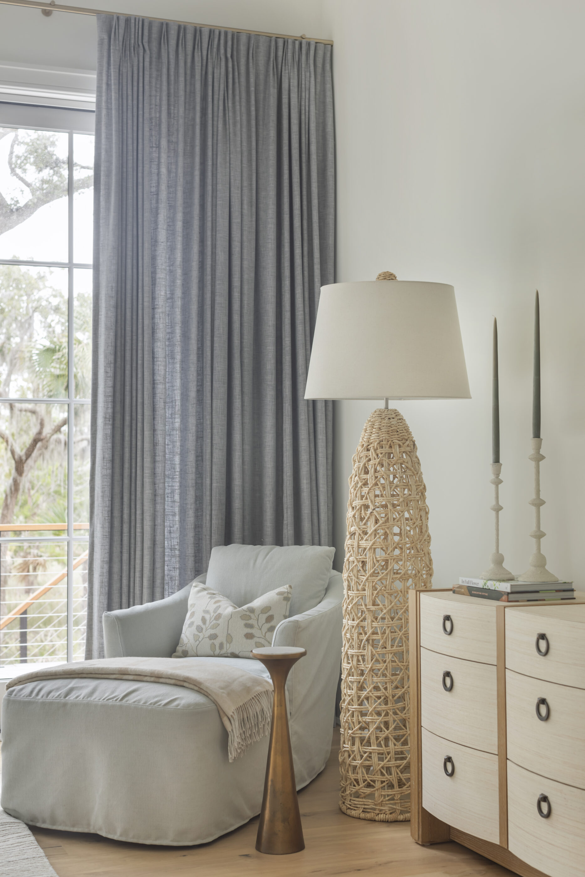 “Lowcountry luxury interior design by Megan Molten featuring coastal modern style, custom upholstery, woven textures, and statement lighting in a serene Kiawah home. Soft blues, neutrals, and sandy tones create an airy atmosphere across kitchen, living room, bedroom, bathroom, and poolside spaces
