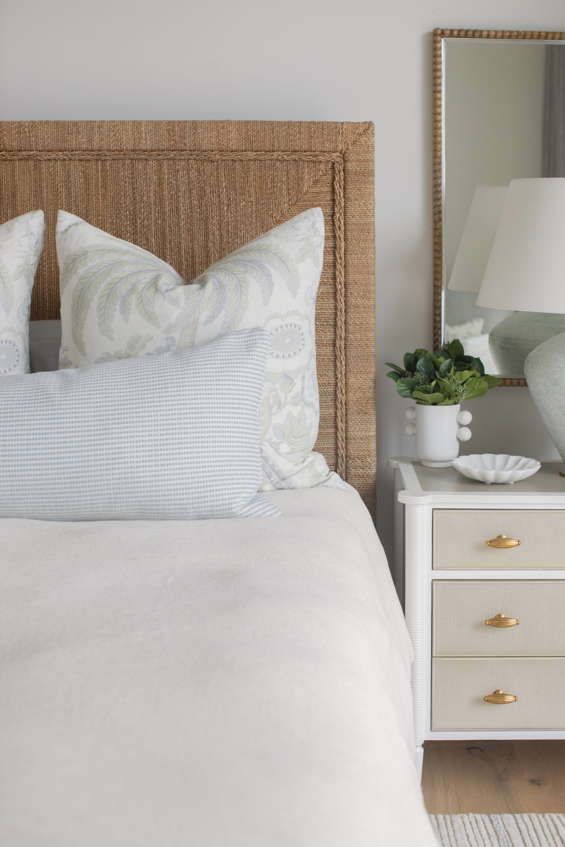 “Lowcountry luxury interior design by Megan Molten featuring coastal modern style, custom upholstery, woven textures, and statement lighting in a serene Kiawah home. Soft blues, neutrals, and sandy tones create an airy atmosphere across kitchen, living room, bedroom, bathroom, and poolside spaces