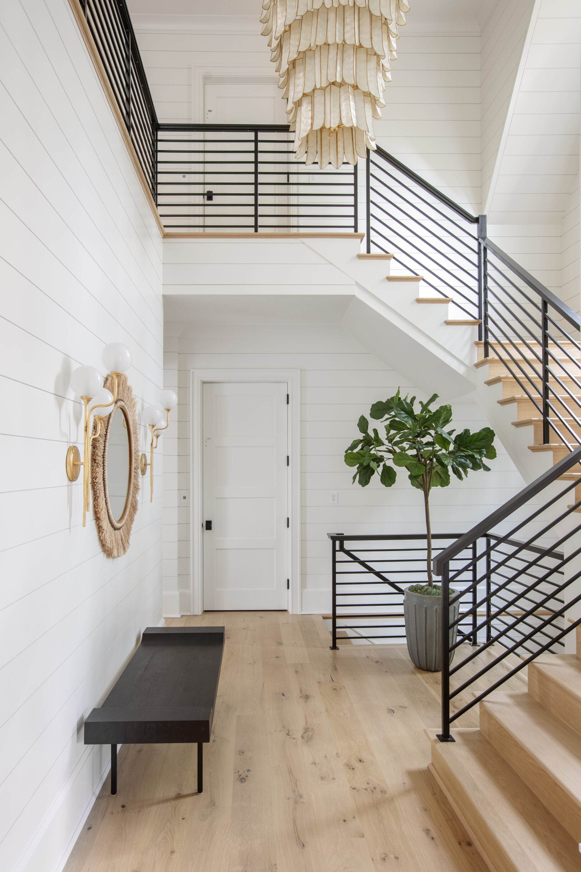 “Lowcountry luxury interior design by Megan Molten featuring coastal modern style, custom upholstery, woven textures, and statement lighting in a serene Kiawah home. Soft blues, neutrals, and sandy tones create an airy atmosphere across kitchen, living room, bedroom, bathroom, and poolside spaces