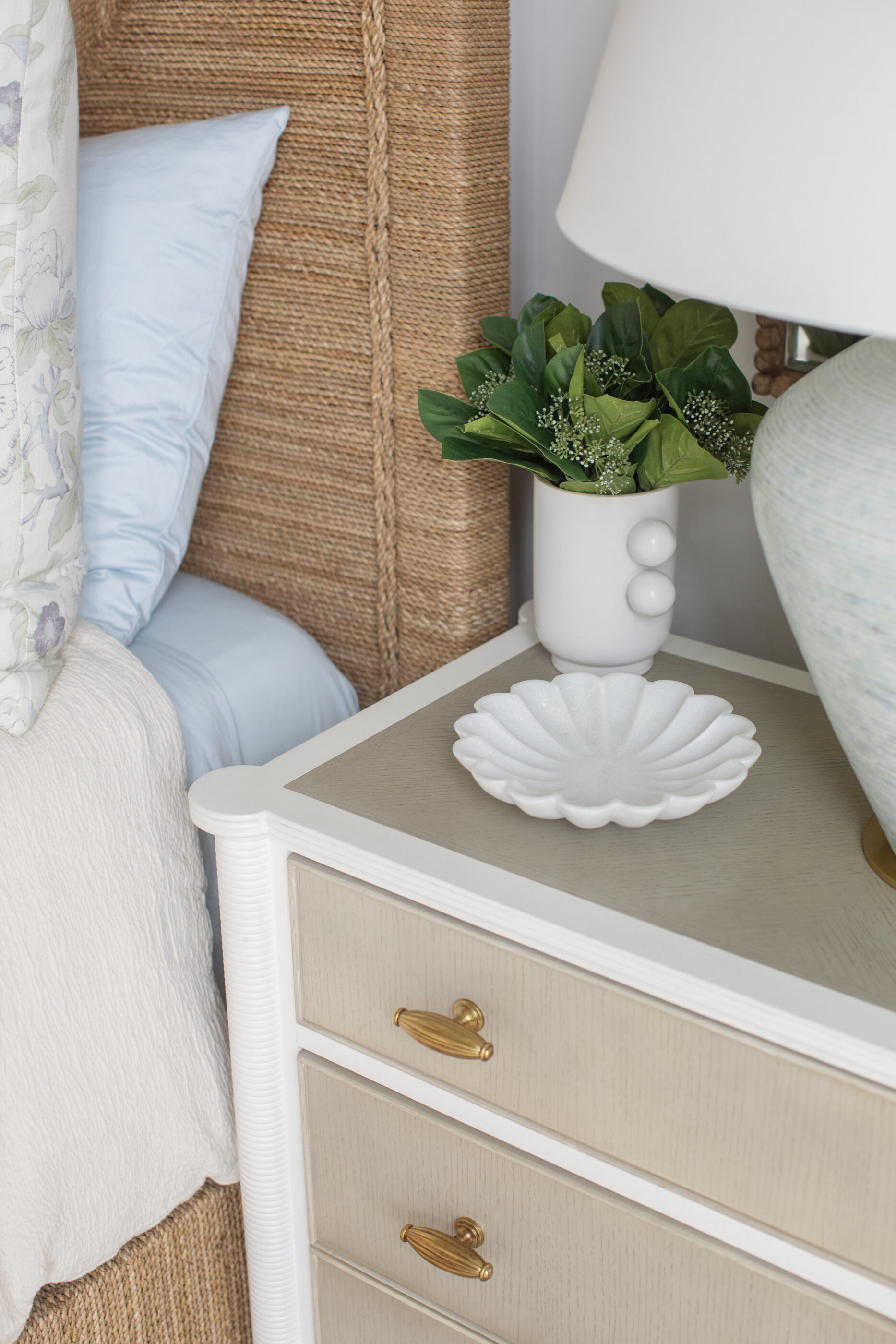 “Lowcountry luxury interior design by Megan Molten featuring coastal modern style, custom upholstery, woven textures, and statement lighting in a serene Kiawah home. Soft blues, neutrals, and sandy tones create an airy atmosphere across kitchen, living room, bedroom, bathroom, and poolside spaces