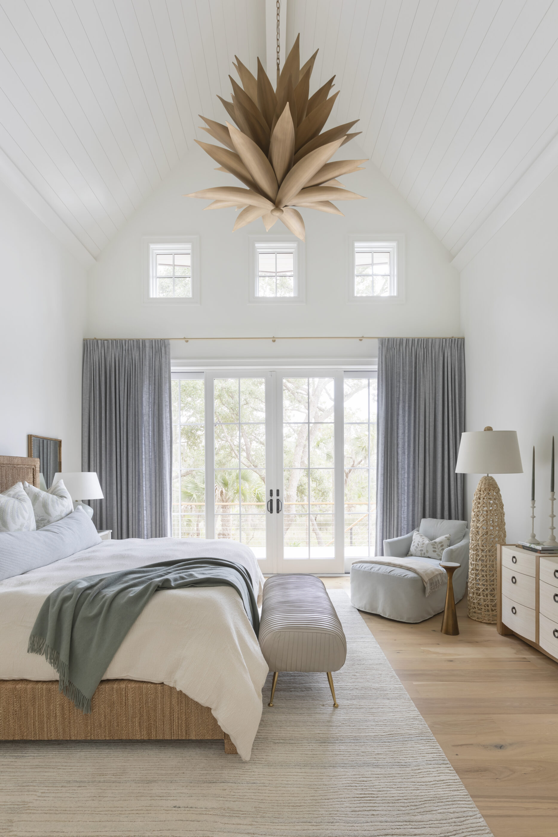 “Lowcountry luxury interior design by Megan Molten featuring coastal modern style, custom upholstery, woven textures, and statement lighting in a serene Kiawah home. Soft blues, neutrals, and sandy tones create an airy atmosphere across kitchen, living room, bedroom, bathroom, and poolside spaces