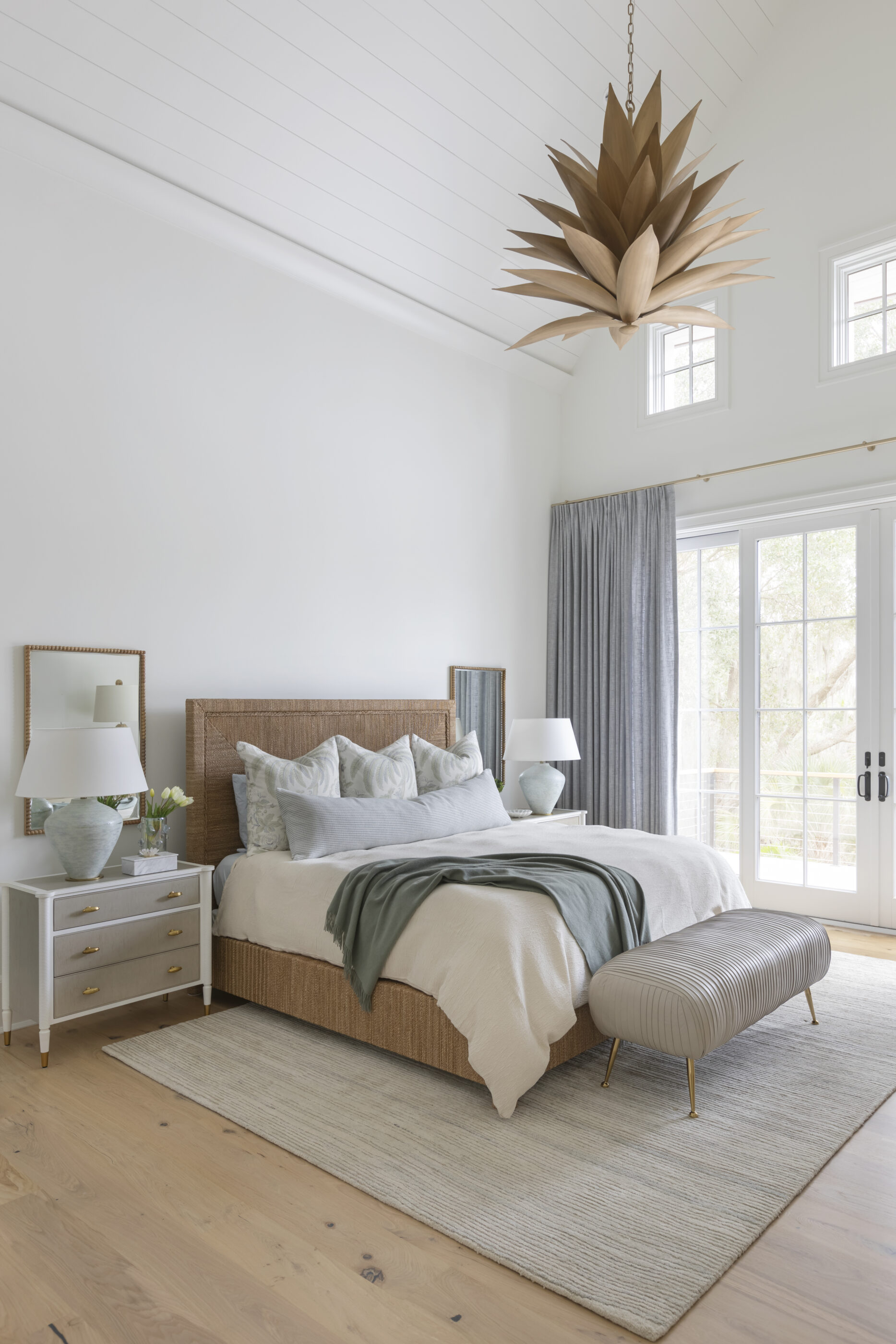 “Lowcountry luxury interior design by Megan Molten featuring coastal modern style, custom upholstery, woven textures, and statement lighting in a serene Kiawah home. Soft blues, neutrals, and sandy tones create an airy atmosphere across kitchen, living room, bedroom, bathroom, and poolside spaces