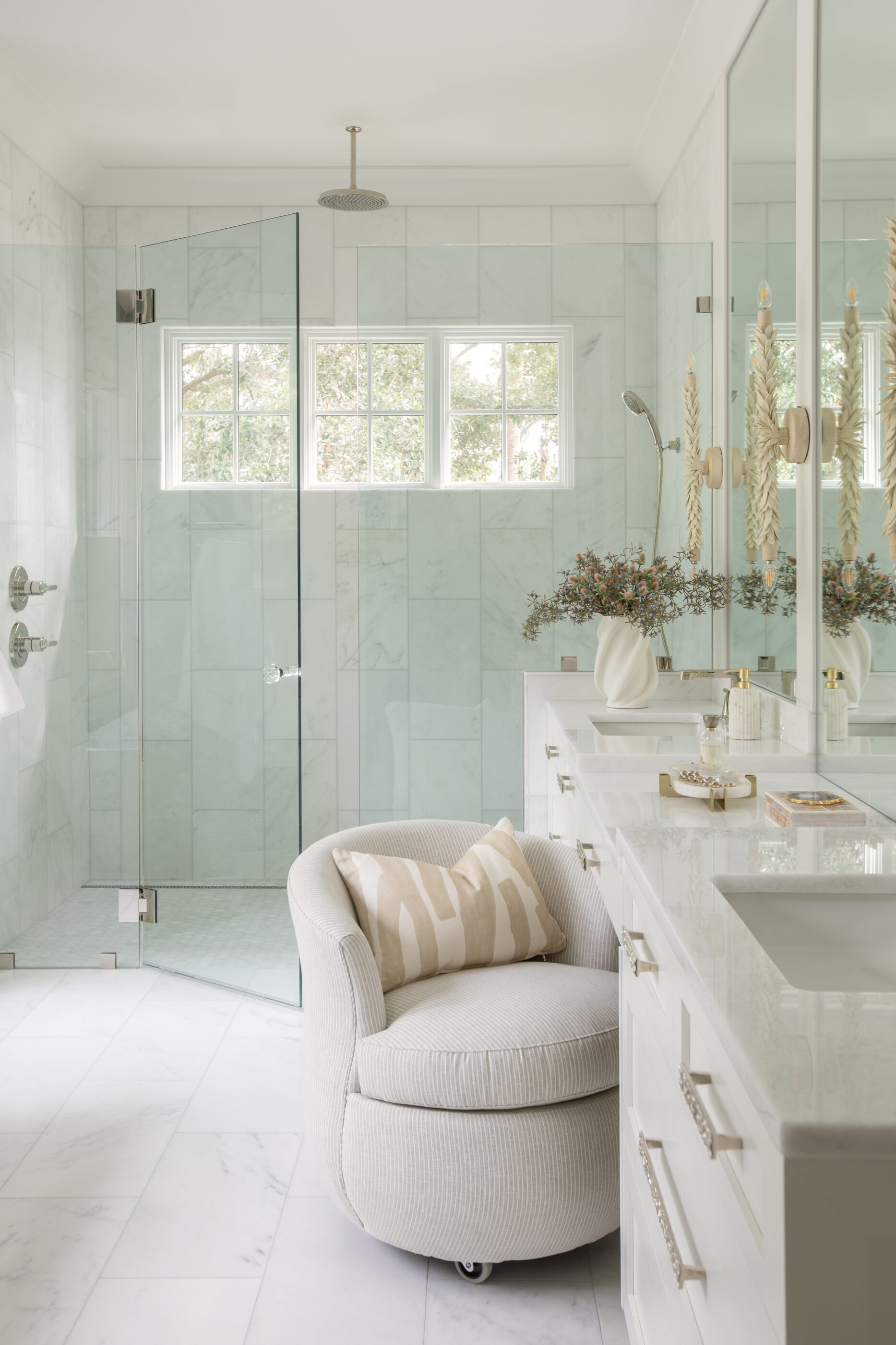 “Lowcountry luxury interior design by Megan Molten featuring coastal modern style, custom upholstery, woven textures, and statement lighting in a serene Kiawah home. Soft blues, neutrals, and sandy tones create an airy atmosphere across kitchen, living room, bedroom, bathroom, and poolside spaces