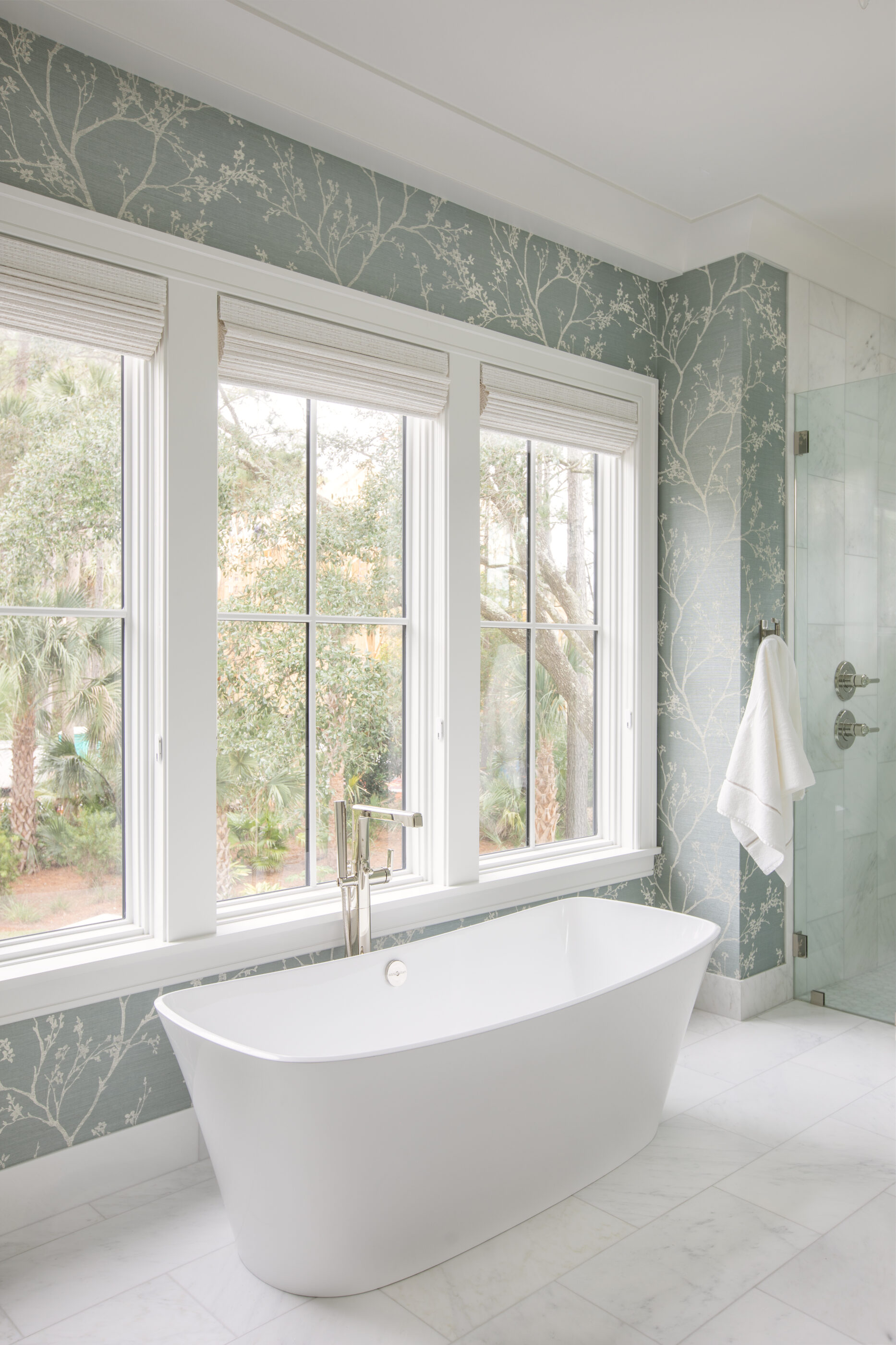 “Lowcountry luxury interior design by Megan Molten featuring coastal modern style, custom upholstery, woven textures, and statement lighting in a serene Kiawah home. Soft blues, neutrals, and sandy tones create an airy atmosphere across kitchen, living room, bedroom, bathroom, and poolside spaces