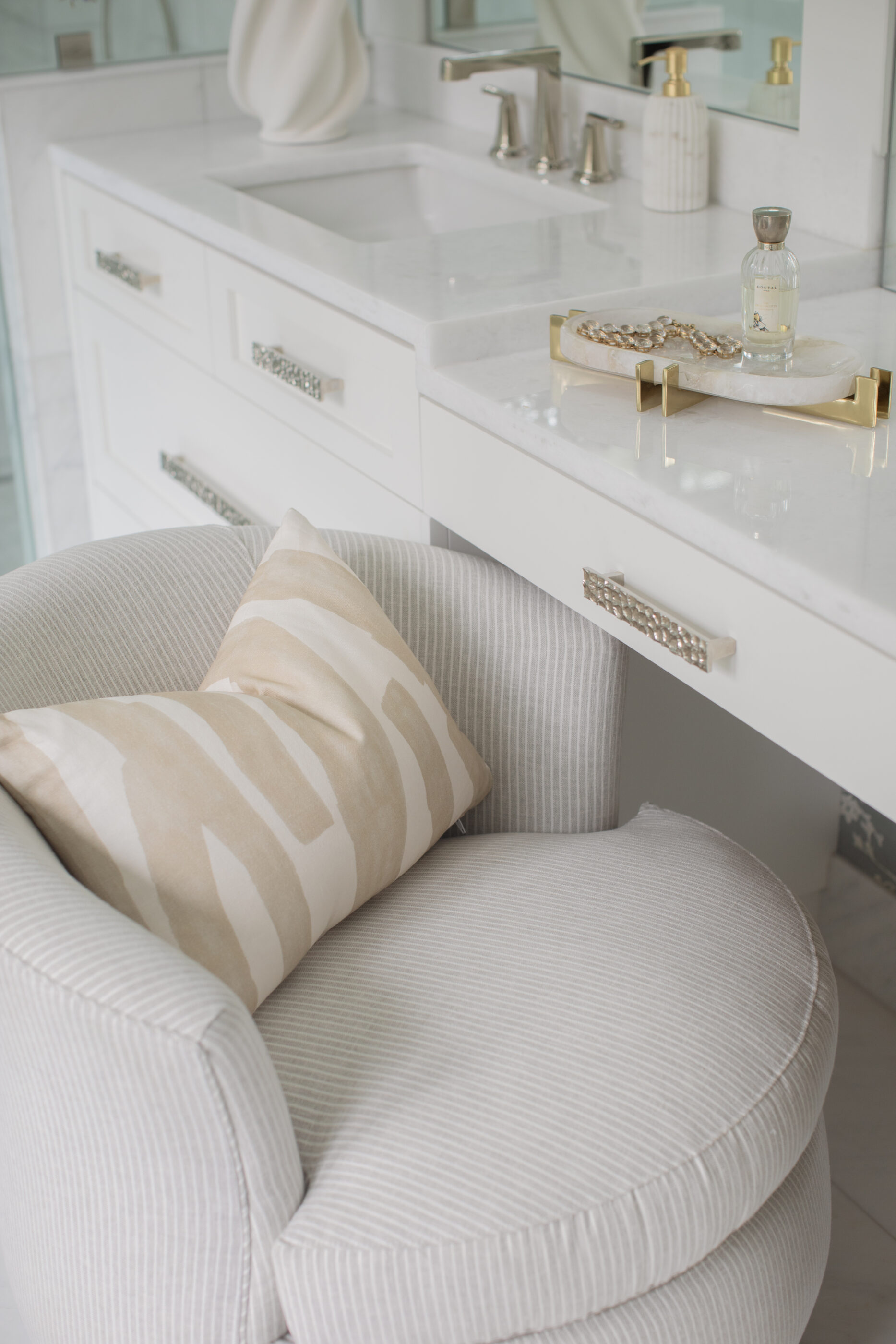 “Lowcountry luxury interior design by Megan Molten featuring coastal modern style, custom upholstery, woven textures, and statement lighting in a serene Kiawah home. Soft blues, neutrals, and sandy tones create an airy atmosphere across kitchen, living room, bedroom, bathroom, and poolside spaces