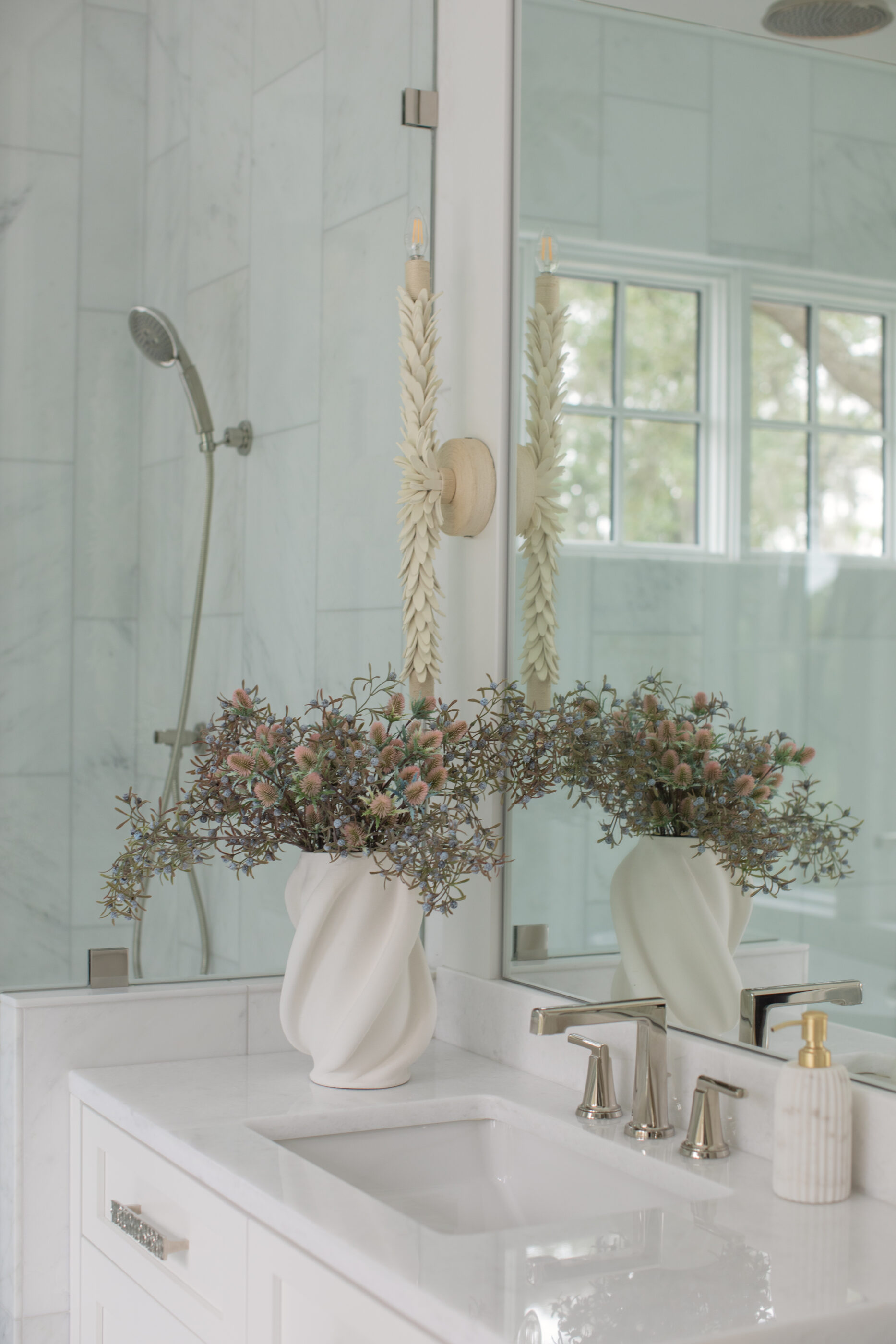 “Lowcountry luxury interior design by Megan Molten featuring coastal modern style, custom upholstery, woven textures, and statement lighting in a serene Kiawah home. Soft blues, neutrals, and sandy tones create an airy atmosphere across kitchen, living room, bedroom, bathroom, and poolside spaces