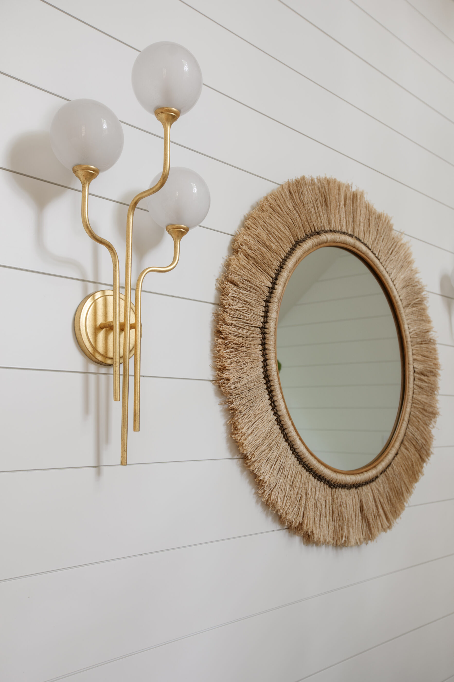 “Lowcountry luxury interior design by Megan Molten featuring coastal modern style, custom upholstery, woven textures, and statement lighting in a serene Kiawah home. Soft blues, neutrals, and sandy tones create an airy atmosphere across kitchen, living room, bedroom, bathroom, and poolside spaces