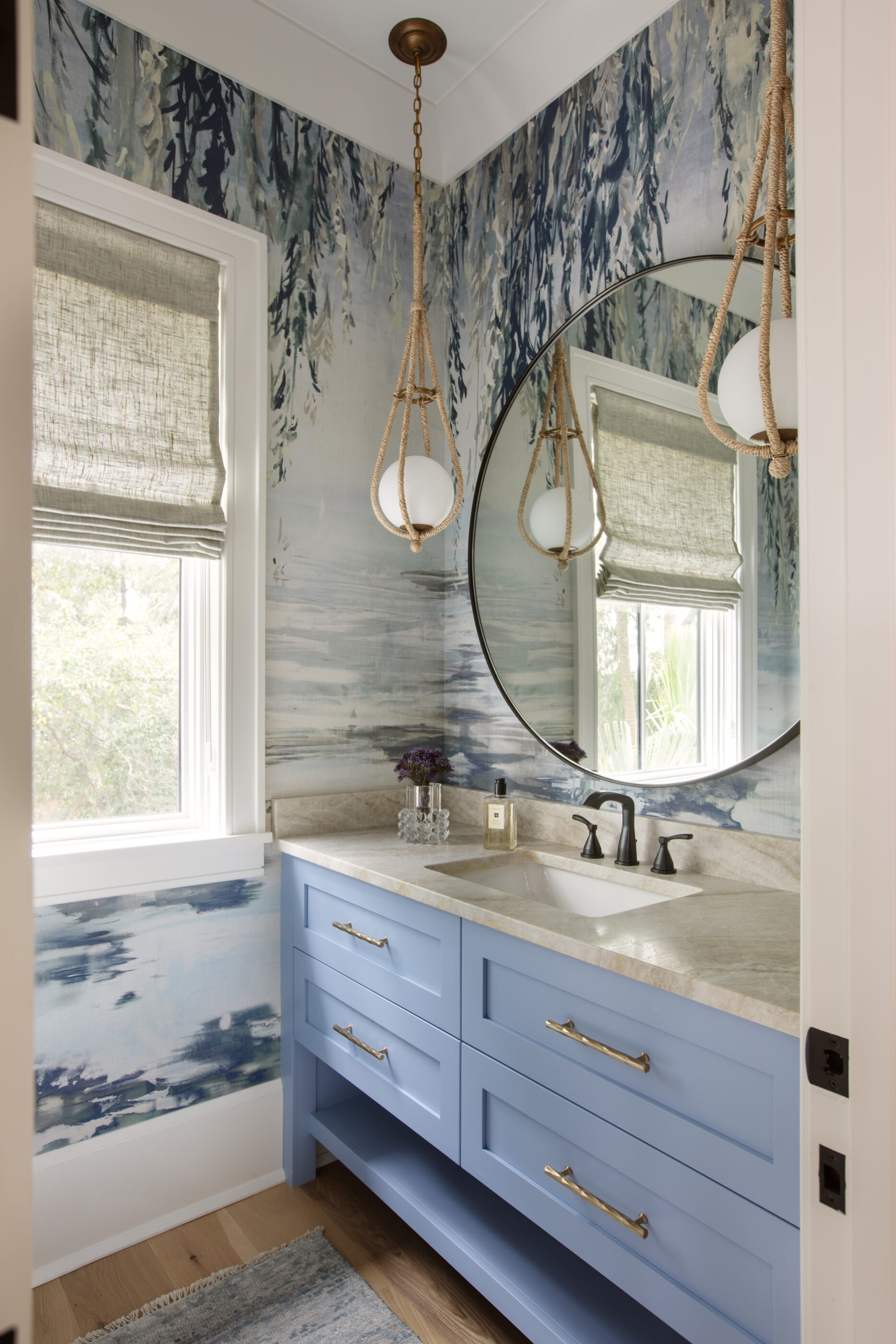 “Lowcountry luxury interior design by Megan Molten featuring coastal modern style, custom upholstery, woven textures, and statement lighting in a serene Kiawah home. Soft blues, neutrals, and sandy tones create an airy atmosphere across kitchen, living room, bedroom, bathroom, and poolside spaces