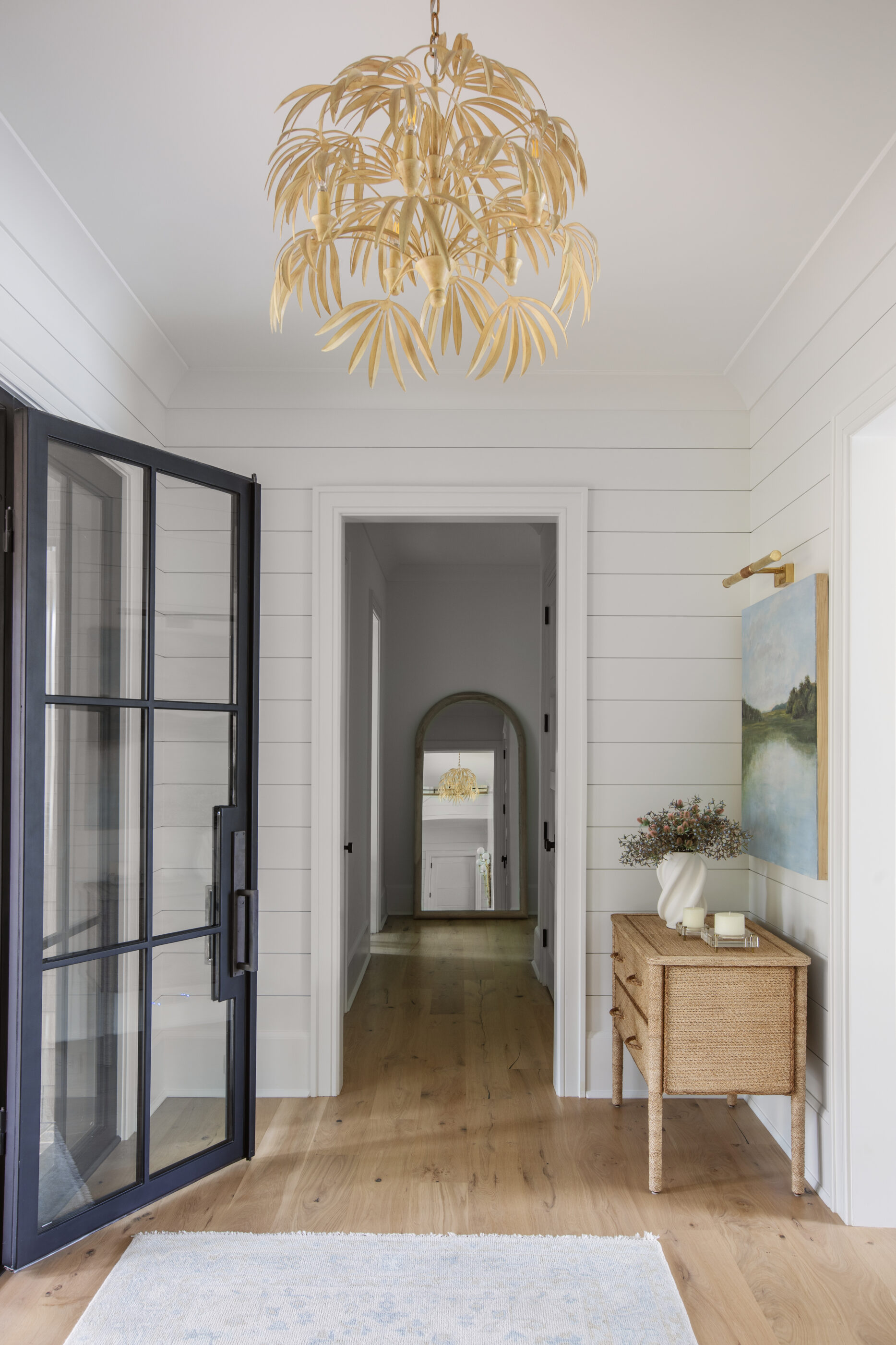 “Lowcountry luxury interior design by Megan Molten featuring coastal modern style, custom upholstery, woven textures, and statement lighting in a serene Kiawah home. Soft blues, neutrals, and sandy tones create an airy atmosphere across kitchen, living room, bedroom, bathroom, and poolside spaces
