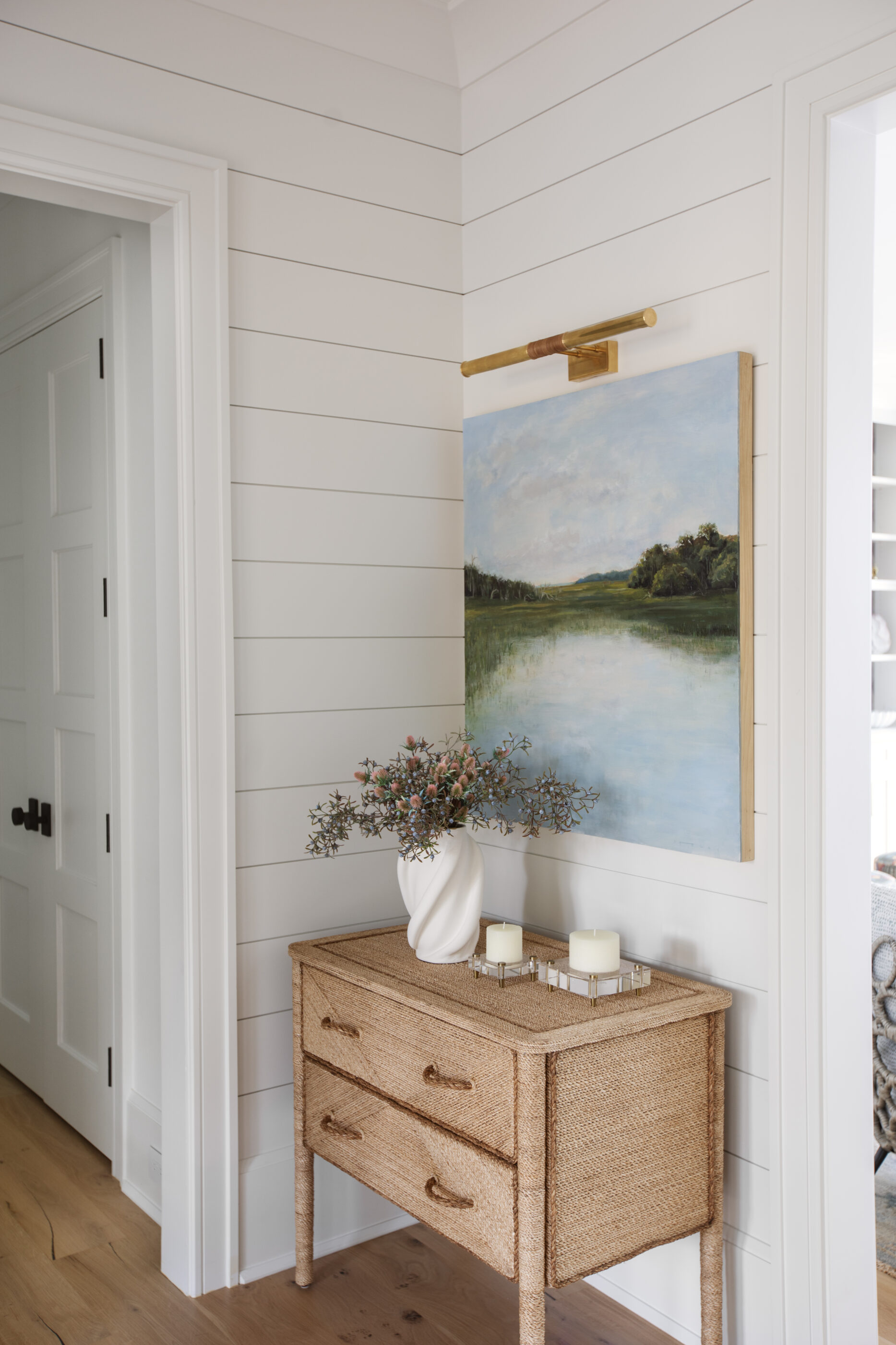“Lowcountry luxury interior design by Megan Molten featuring coastal modern style, custom upholstery, woven textures, and statement lighting in a serene Kiawah home. Soft blues, neutrals, and sandy tones create an airy atmosphere across kitchen, living room, bedroom, bathroom, and poolside spaces