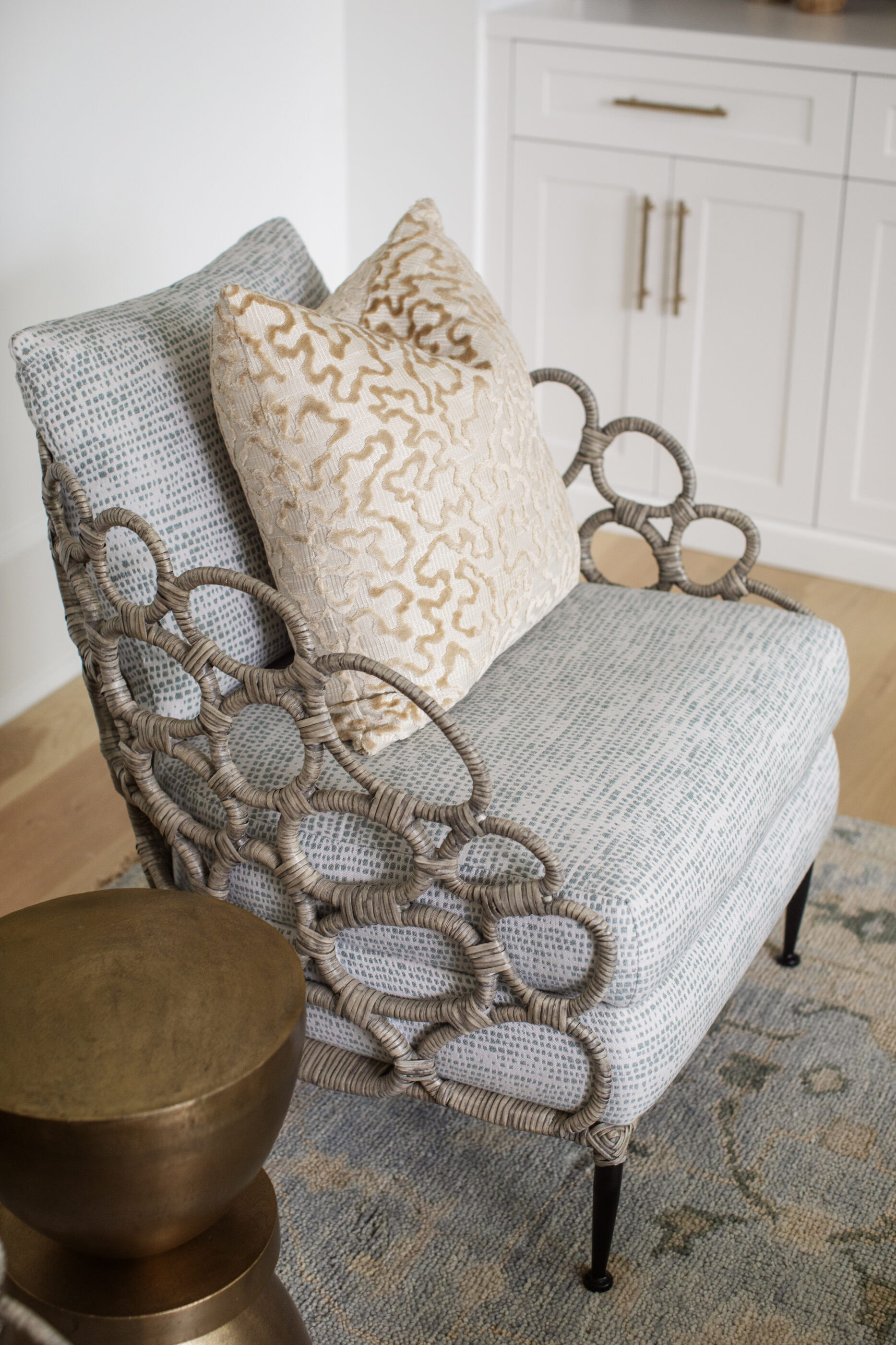 “Lowcountry luxury interior design by Megan Molten featuring coastal modern style, custom upholstery, woven textures, and statement lighting in a serene Kiawah home. Soft blues, neutrals, and sandy tones create an airy atmosphere across kitchen, living room, bedroom, bathroom, and poolside spaces