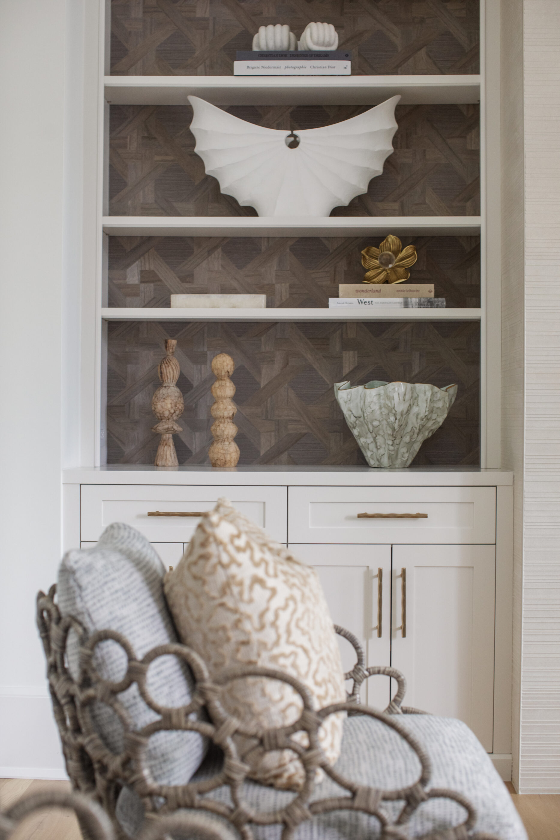 “Lowcountry luxury interior design by Megan Molten featuring coastal modern style, custom upholstery, woven textures, and statement lighting in a serene Kiawah home. Soft blues, neutrals, and sandy tones create an airy atmosphere across kitchen, living room, bedroom, bathroom, and poolside spaces