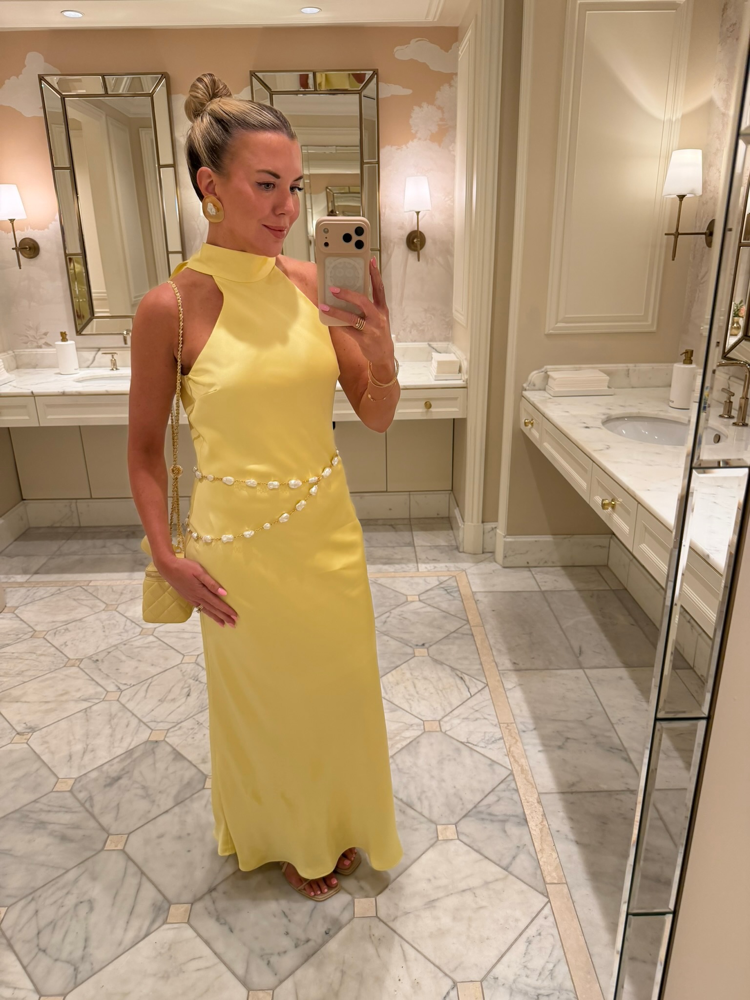Megan Molten wearing a yellow dress with a matching yellow handbag for a bright monochromatic summer outfit.