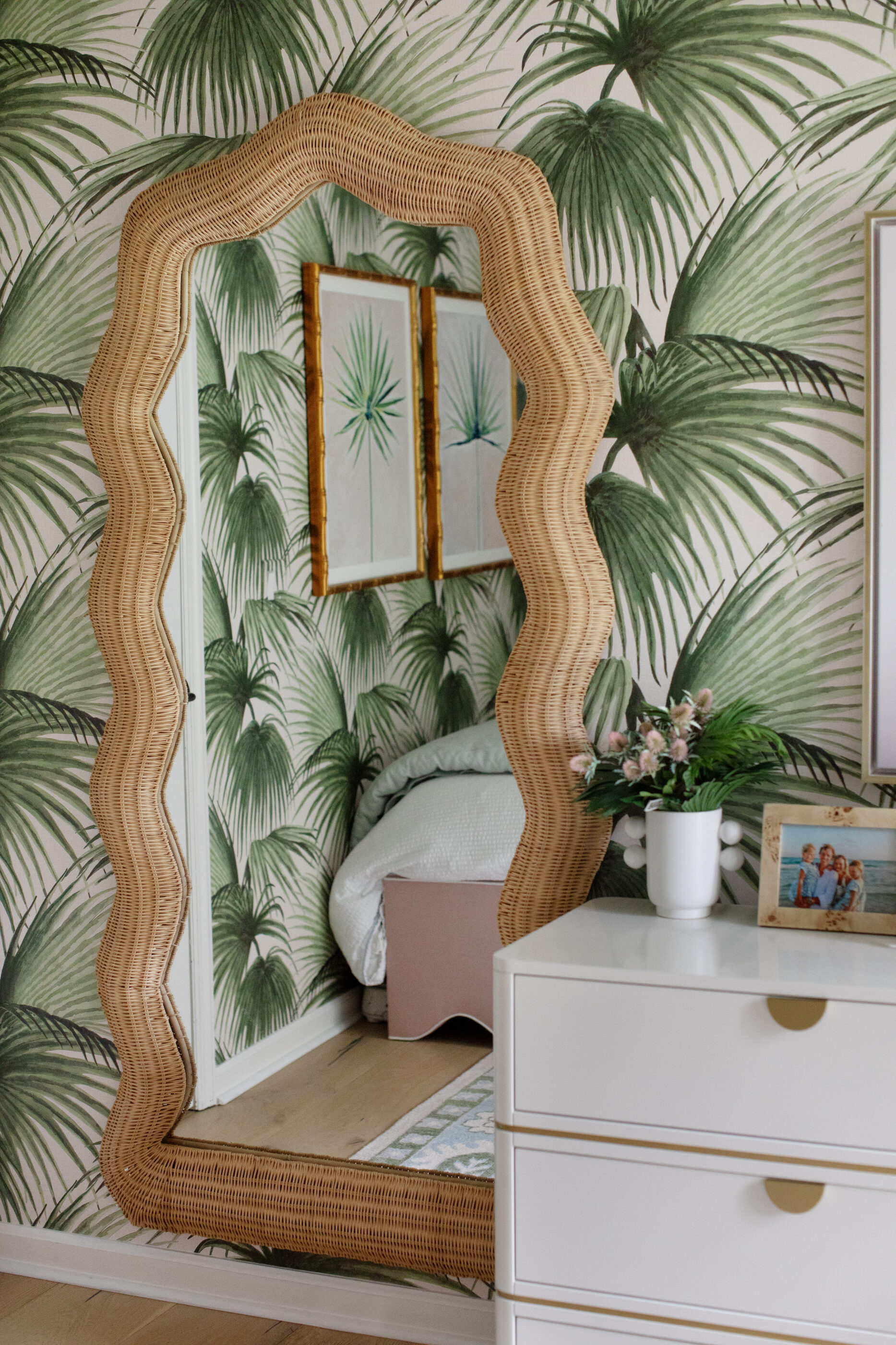 Maxine woven rattan mirror styled with tropical wallpaper for unique bedroom wall decor